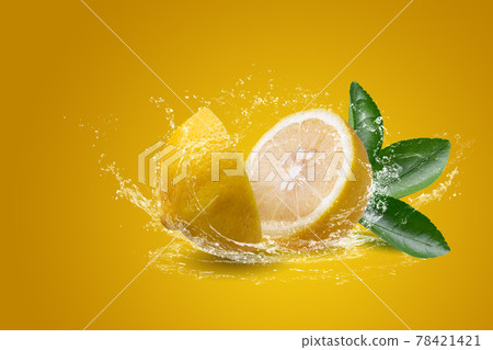Water splashing on Sliced lemon fruit isolated on yellow background 78421421