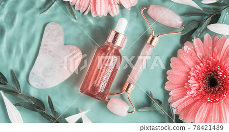 Cosmetic serum oil acid bottle with face pink quartz roller 78421489