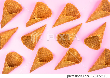 Waffle empty ice cream cones on a colored pink background Waffle empty ice cream cones on a colored pink background 78422510
