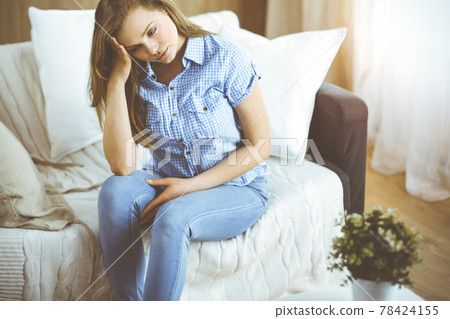 Tired upset woman worried about tiredness from domestic work and self isolation quarantine for COVID-19 Coronavirus 78424155