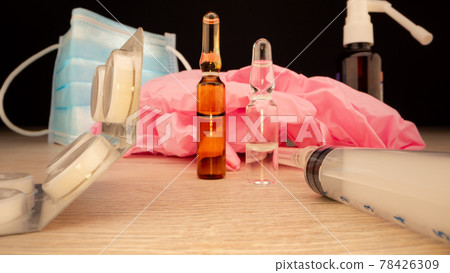 Coronavirus vaccines in coloured vials stand on table Coronavirus vaccines in coloured vials stand on table 78426309