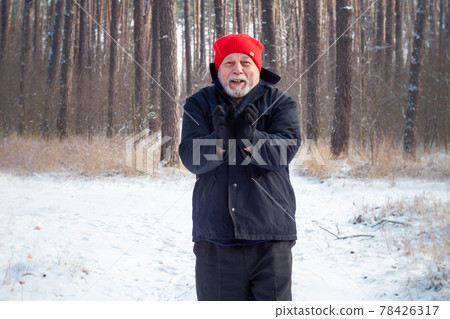 Delighted aged man with grey beard poses joining hands Delighted aged man with grey beard poses joining hands 78426317