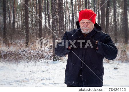 Cheerful aged man with beard admires nature on winter day Cheerful aged man with beard admires nature on winter day 78426323