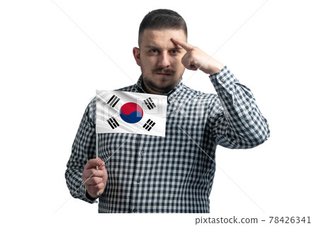 White guy holding a flag of South Korea and a finger touches the temple on the head isolated on a white background White guy holding a flag of South Korea and a finger touches the temple on the head isolated on a white background 78426341