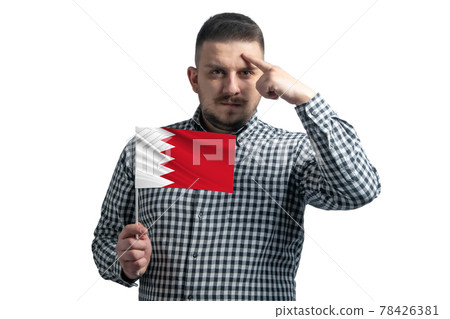 White guy holding a flag of Bahrain and a finger touches the temple on the head isolated on a white background 78426381