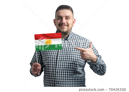 White guy holding a flag of Kurdistan and points the finger of the other hand at the flag isolated on a white background 78426388