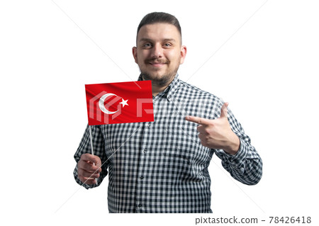 White guy holding a flag of Turkey and points the finger of the other hand at the flag isolated on a white background White guy holding a flag of Turkey and points the finger of the other hand at the flag isolated on a white background 78426418