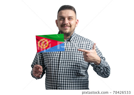 White guy holding a flag of Eritrea and points the finger of the other hand at the flag isolated on a white background 78426533