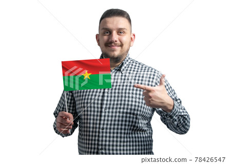 White guy holding a flag of Burkina Faso and points the finger of the other hand at the flag isolated on a white background White guy holding a flag of Burkina Faso and points the finger of the other hand at the flag isolated on a white background 78426547