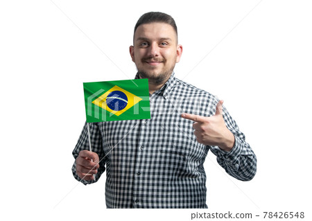 White guy holding a flag of Brazil and points the finger of the other hand at the flag isolated on a white background White guy holding a flag of Brazil and points the finger of the other hand at the flag isolated on a white background 78426548