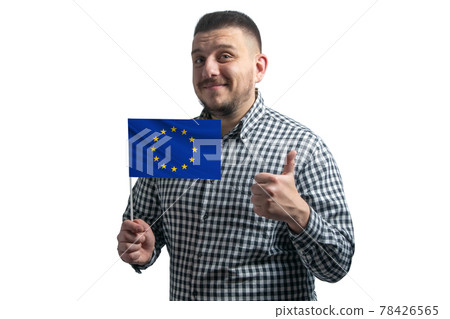 White guy holding a flag of European Union and shows the class by hand isolated on a white background. Like for European Union White guy holding a flag of European Union and shows the class by hand isolated on a white background. Like for European Union 78426565