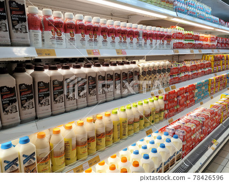 PENANG, MALAYSIA -JULY 9, 2020: Selected focused on milk drinks in boxes that come with various flavors and brands. Displayed on cold shelves. Placed price tag. 78426596