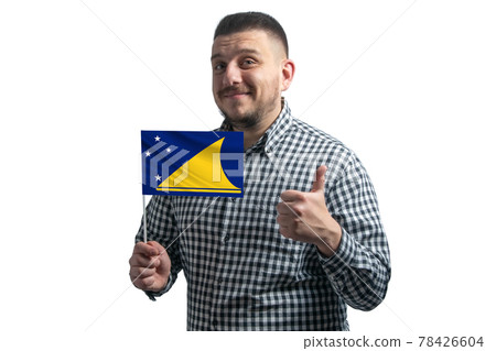 White guy holding a flag of Tokelau and shows the class by hand isolated on a white background. Like for Tokelau White guy holding a flag of Tokelau and shows the class by hand isolated on a white background. Like for Tokelau 78426604
