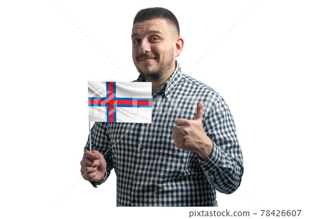White guy holding a flag of Faroe Islands and shows the class by hand isolated on a white background. Like for Faroe Islands White guy holding a flag of Faroe Islands and shows the class by hand isolated on a white background. Like for Faroe Islands 78426607