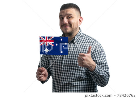 White guy holding a flag of Australia and shows the class by hand isolated on a white background. Like for Australia White guy holding a flag of Australia and shows the class by hand isolated on a white background. Like for Australia 78426762