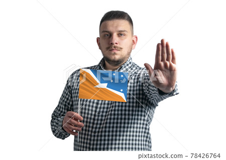 White guy holding a flag of Argentine Antarctica and with a serious face shows a hand stop sign isolated on a white background 78426764