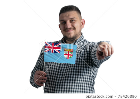 White guy holding a flag of Fiji and points forward in front of him isolated on a white background 78426880