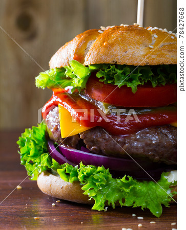 Hamburger with beef and ketchup, tomato, cheese, cucumber and lettuce 78427668