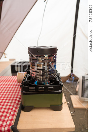 [The inside of the tent is warm with a stove] 78428592
