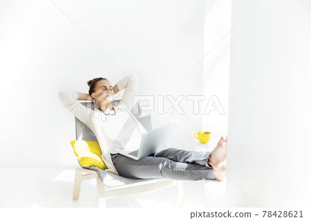 Young woman resting with laptop 78428621