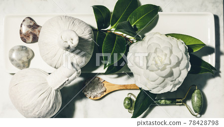 Flat lay composition with spring camelia flower and various beauty care products on white marble table Flat lay composition with spring camelia flower and various beauty care products on white marble table 78428798