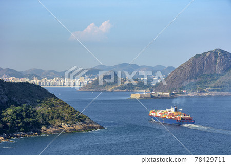 Cargo ship entering Guanabara Bay through the mountains and forests 78429711