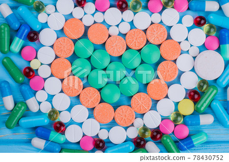 Many various medicine pills and tablets arranged in a shape of heart. 78430752