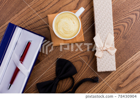 Cup of coffee with gift boxes and bow tie. Cup of coffee with gift boxes and bow tie. 78430904