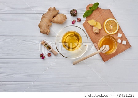 Cup of tea, lemon and ginger on wooden background. Cup of tea, lemon and ginger on wooden background. 78431225