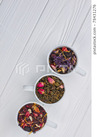 Set of dried tea on white wooden background. Set of dried tea on white wooden background. 78431276