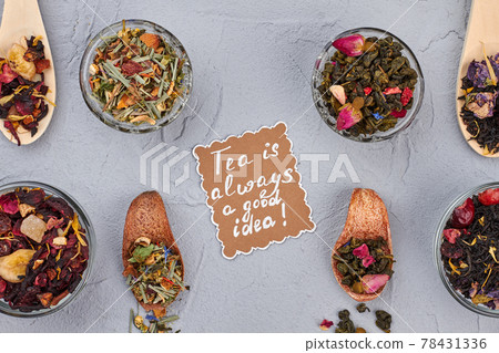Spoons and bowls with different type of dry tea leaves. 78431336