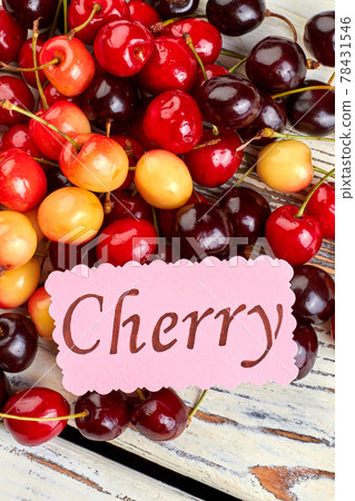 Delicious summer cherries on wooden background. 78431546