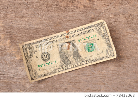 One dollar bills on a wooden background. One dollar bills on a wooden background. 78432368