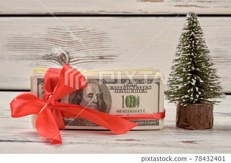 Dollars with red ribbon bow. 78432401