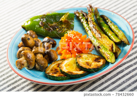 Assortment of delicious grilled organic vegetables served on blue ceramic plate. Assortment of delicious grilled organic vegetables served on blue ceramic plate. 78432660