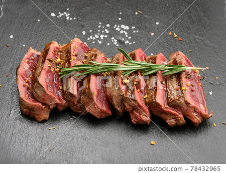 sliced fried beef steak New York striploin on a black background with spices, degree of doneness rare sliced fried beef steak New York striploin on a black background with spices, degree of doneness rare 78432965
