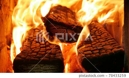 Burning firewood in the fireplace close up. 78433259