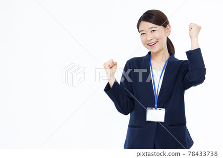 Business woman in her thirties doing a guts pose Business woman in her thirties doing a guts pose 78433738
