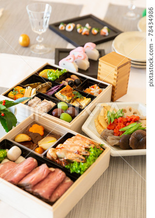 Double-tiered table setting for Western-style New Year dishes 78434986