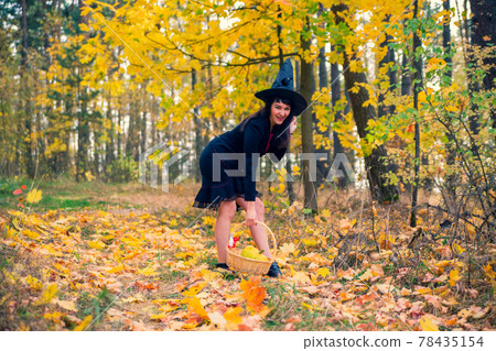 witch in the autumn forest. halloween cosplay. halloween fall holiday celebration witch in the autumn forest. halloween cosplay. halloween fall holiday celebration 78435154
