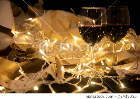 two glasses of red wine stand in a shining garland two glasses of red wine stand in a shining garland 78435356