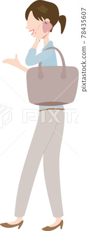 A woman walking while talking on a smartphone A woman walking while talking on a smartphone 78435607