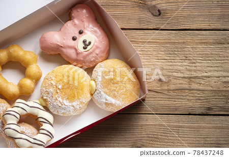 Different type of donuts set, sweet donuts in a paper donut box dessert snack food. 78437248