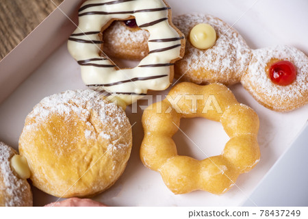 Different type of donuts set, sweet donuts in a paper donut box dessert snack food. top view 78437249