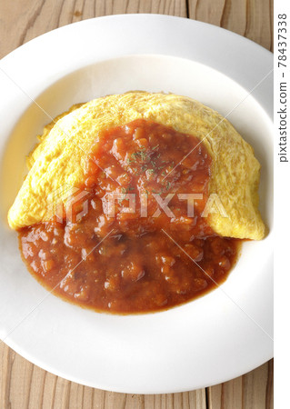 Take a bird's-eye view of a hot omelet rice or omelet with meat sauce on a wooden board 78437338