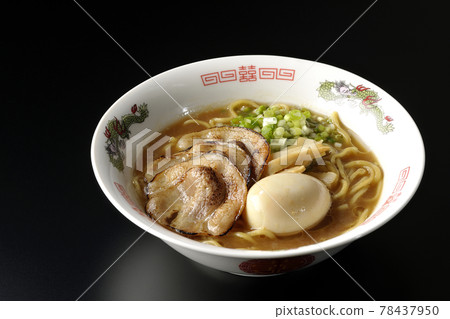 Photographed pork bone soy sauce ramen with roasted char siu, taste balls, menma and all-purpose green onions on a black background Photographed pork bone soy sauce ramen with roasted char siu, taste balls, menma and all-purpose green onions on a black background 78437950
