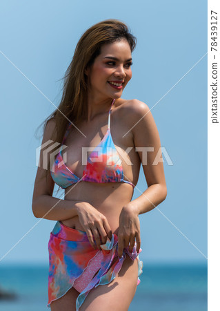 Portrait of thai woman posing outdoors at the sea beach 78439127