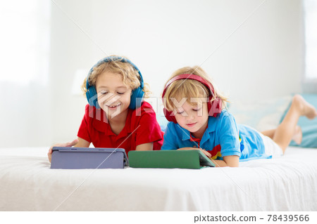 Child with tablet computer. Kids study online. 78439566