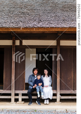 A family of three in an old folk house 78440202