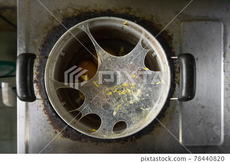 Exploding boiled eggs in a dirty pot on a dirty gas stove Exploding boiled eggs in a dirty pot on a dirty gas stove 78440820